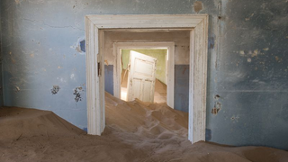Colorful Desert Ruins Consumed by Waves of Sand